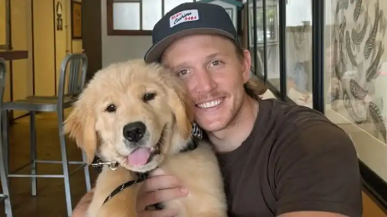 Golden Retriever Still Getting Carried Around Like A Baby By His Dad Is Pure Love